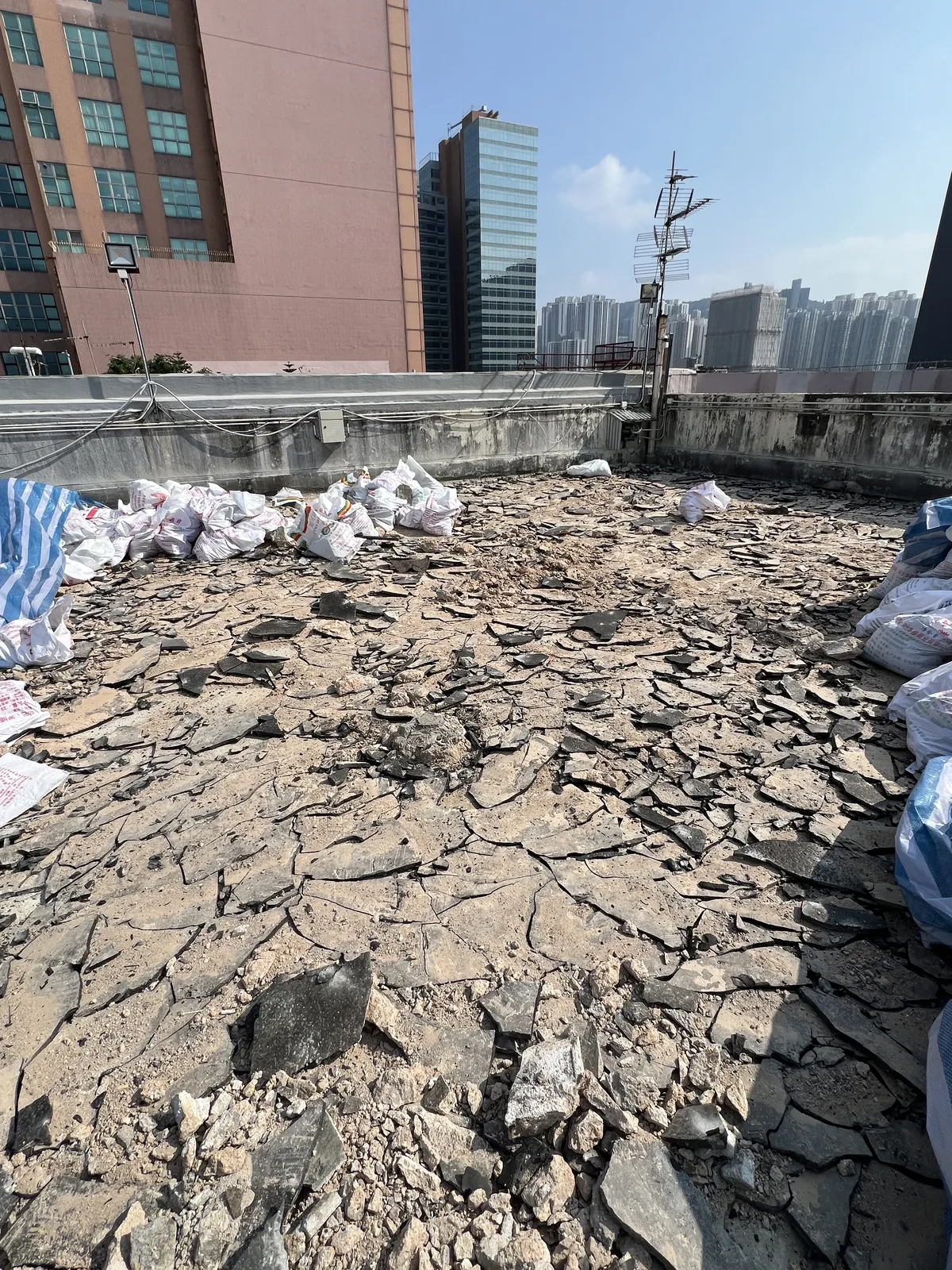 觀塘鴻運工業大廈工程:已拆除舊面層並堆有碎料的天台